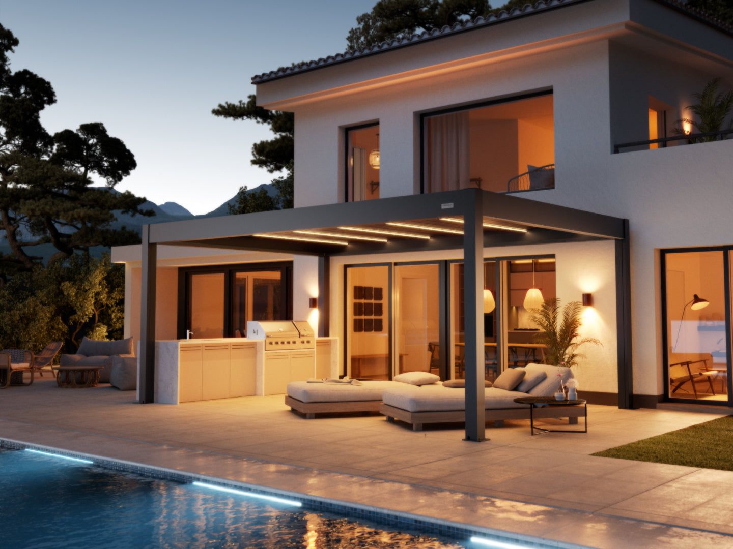  A wide-angle view of a luxurious modern home's patio at dusk. A large, dark gray pergola with integrated LED strip lighting covers the main section of a paved terrace. Beneath the pergola, there is comfortable outdoor seating, including a modular chaise lounge and a small side table. To the left, there is a built-in outdoor kitchen and grill area. The patio extends to a seating area beneath another overhang on the far left. In the foreground, the edge of a swimming pool is visible, illuminated by a glowing